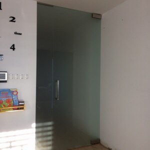 sklenená stena s otočnými dverami z matného skla